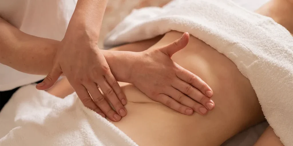Therapist performs abdominal lymphatic drainage massage at The Spa at Fig Garden Village in Fresno