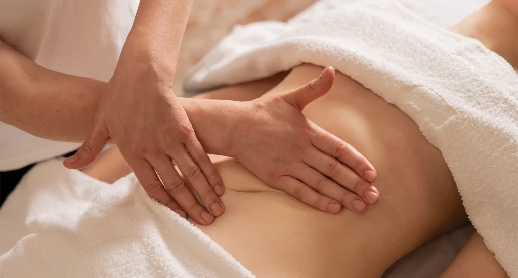 Therapist performs abdominal lymphatic drainage massage at The Spa at Fig Garden Village in Fresno